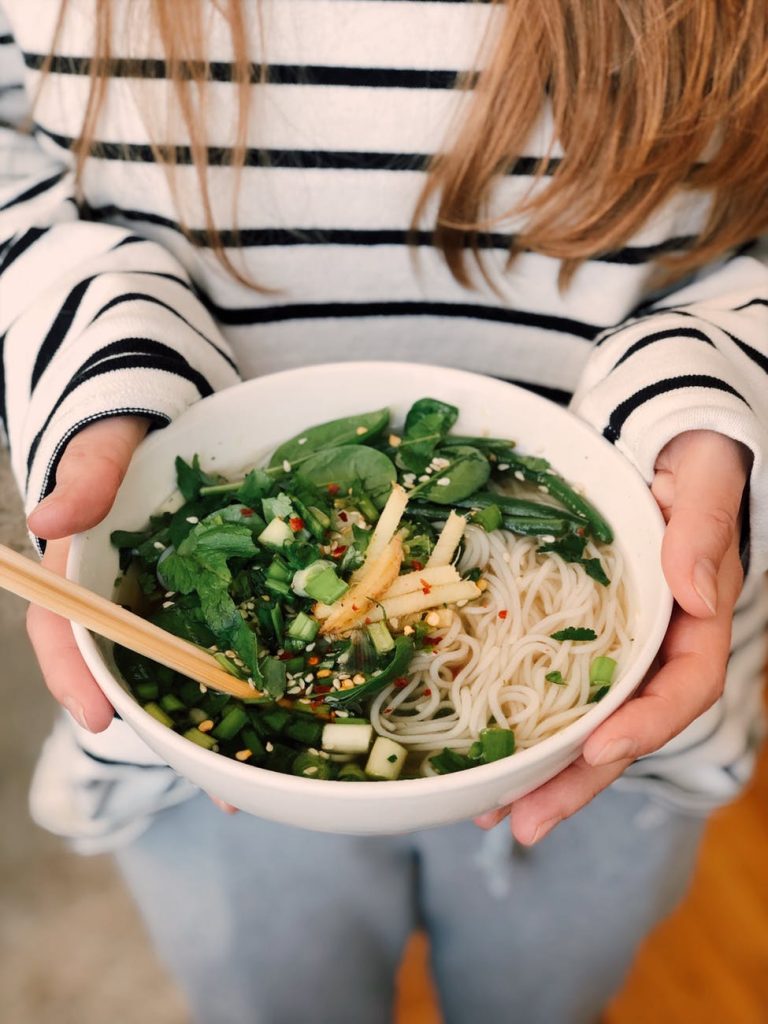 woman holding a bowl of Healthy Noodle Meal